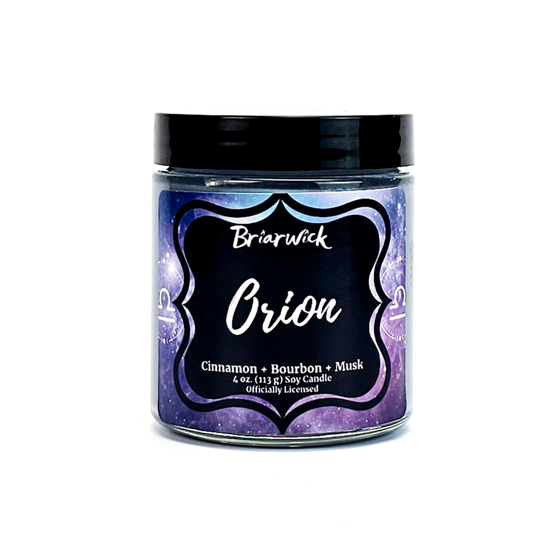 Orion 4oz flint gray candle with gray galaxy libra design on a white background
