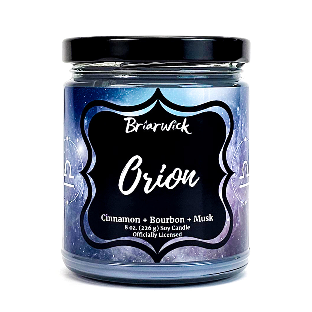 Orion 8oz flint gray candle with gray galaxy libra design on a white background