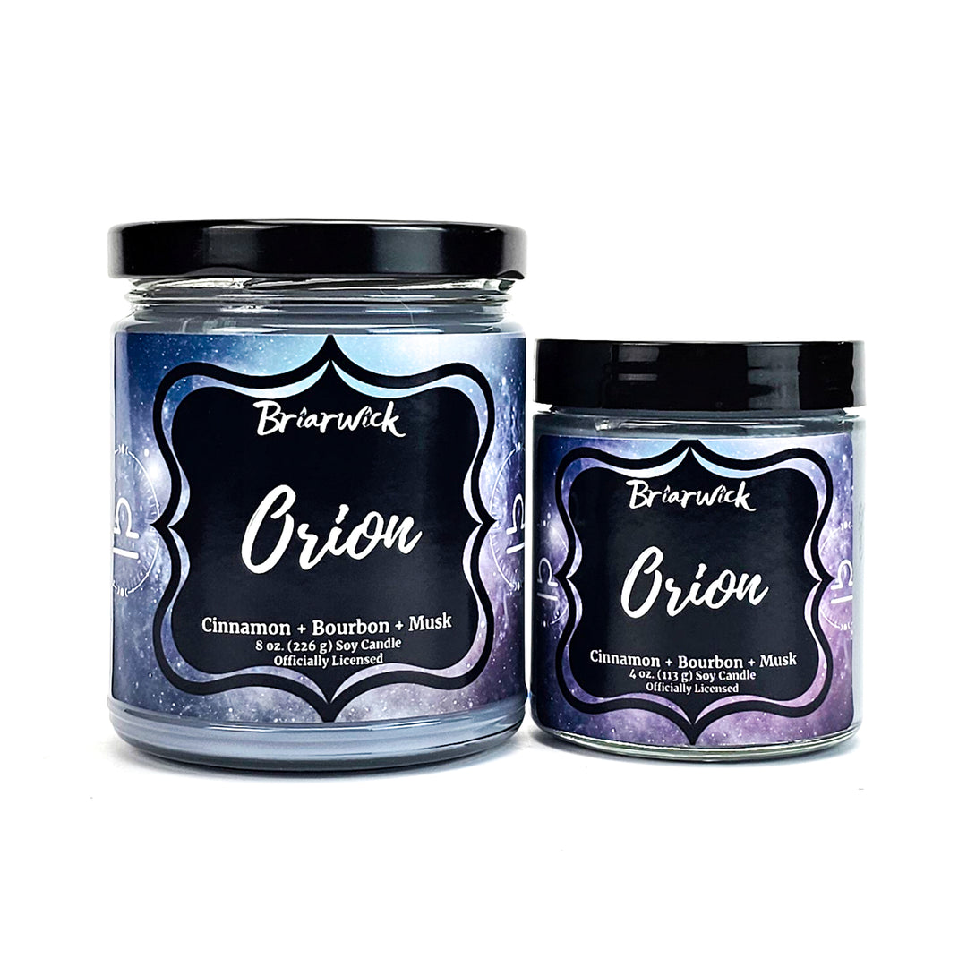 Orion 8oz & 4oz flint gray candles with gray galaxy libra designs on a white background